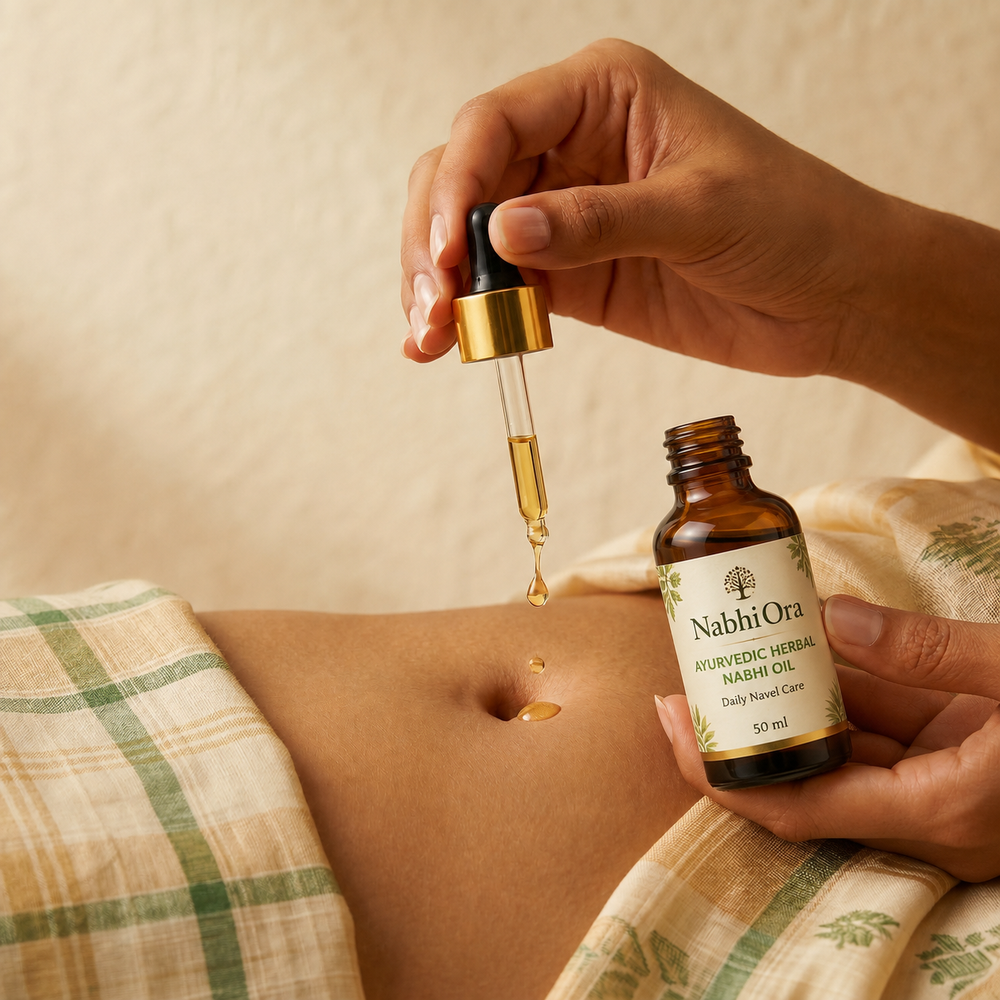 Applying NabhiOra Ayurvedic Herbal Nabhi Oil with dropper